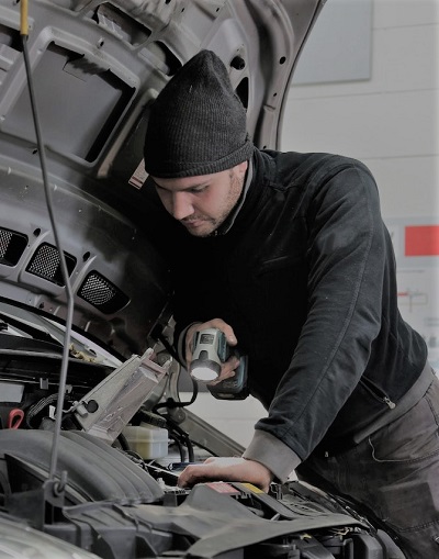 Mechanic Inspects Engine Compartment